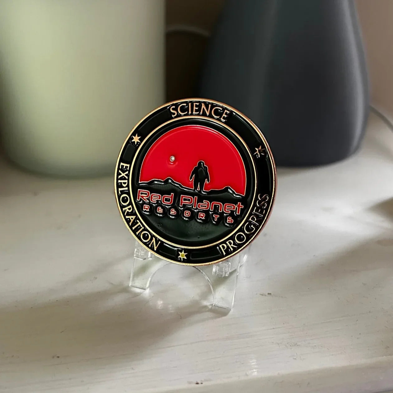 Red Planet Resorts commemorative coin with astronaut and Mars landscape on display stand