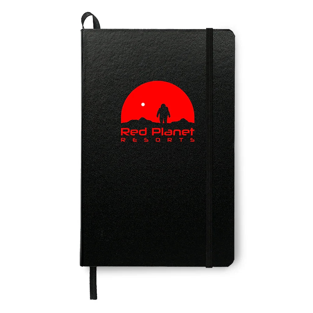 Black notebook with elastic band featuring a red logo of an astronaut and text Red Planet Resorts