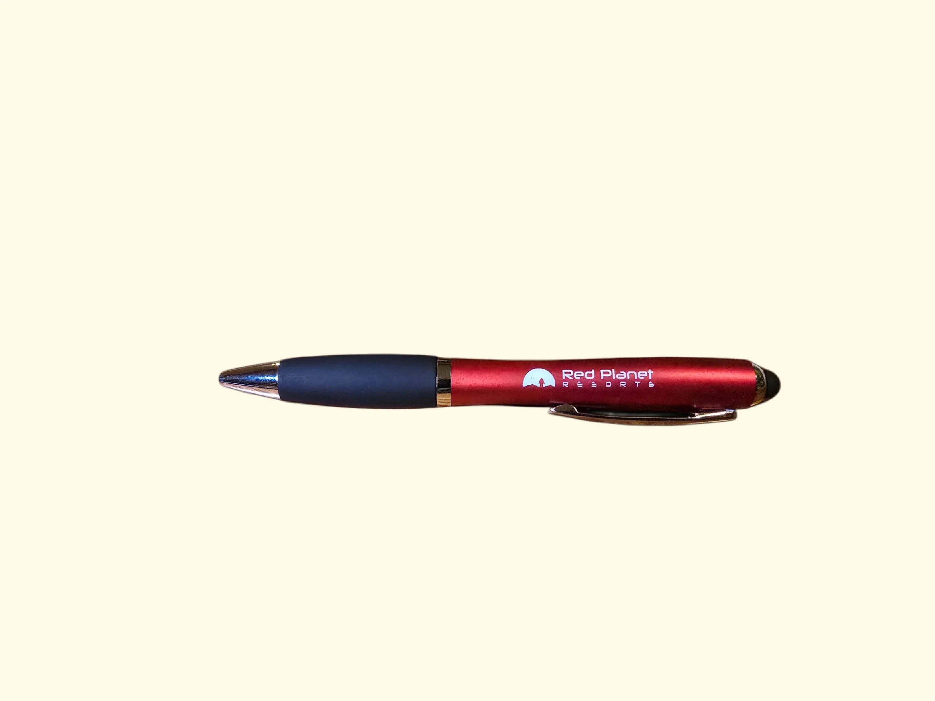 Red Planet Resorts branded red pen with black grip and silver tip on plain background