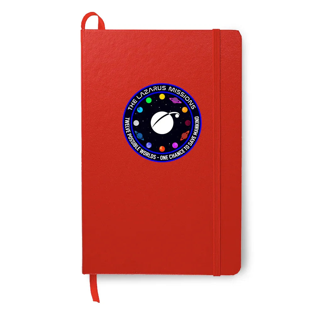 Red notebook with elastic band and spacecraft mission patch reading The Lazarus Missions on cover
