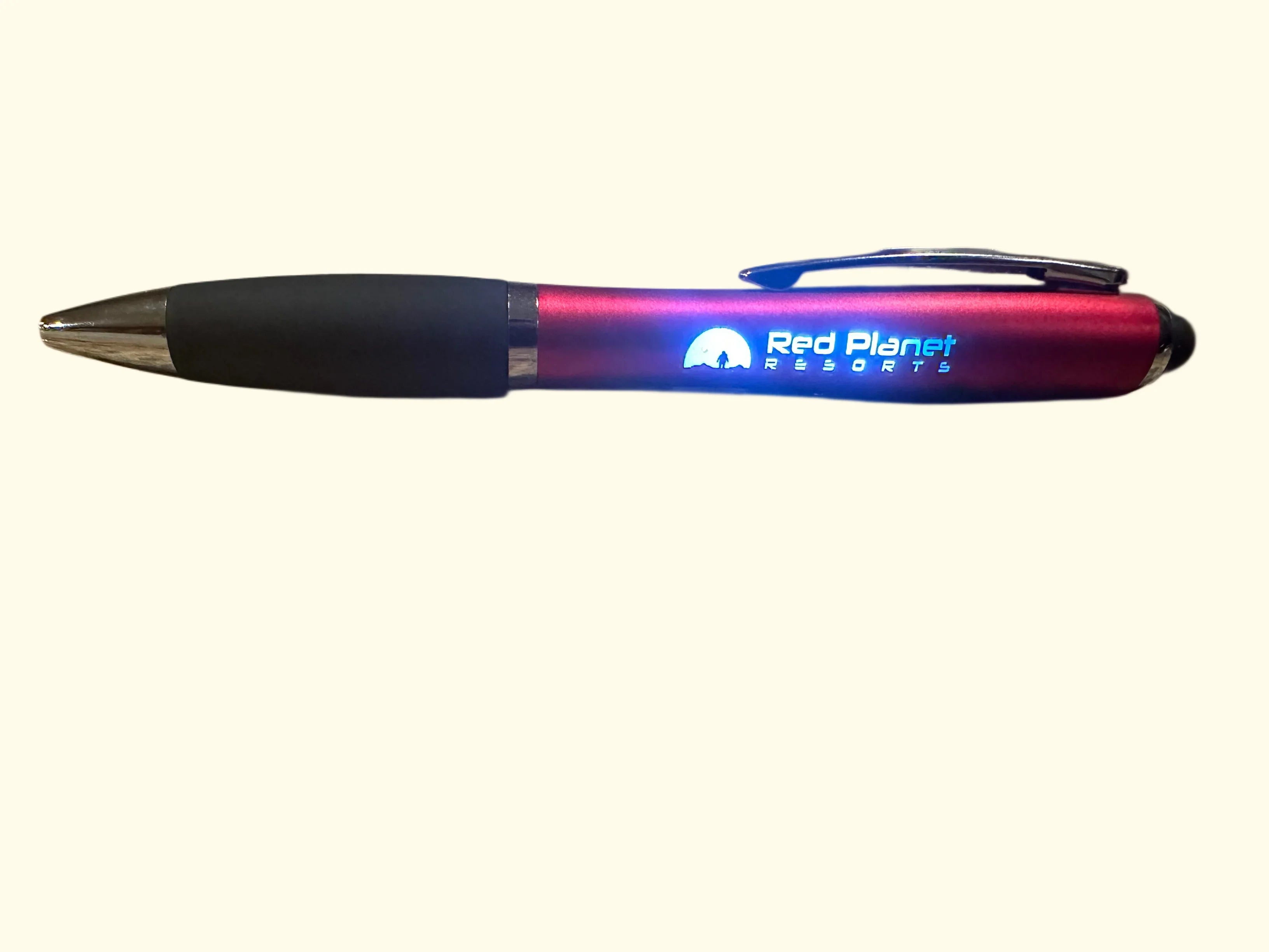 Red Planet Resorts branded red and black promotional pen with clip on white background
