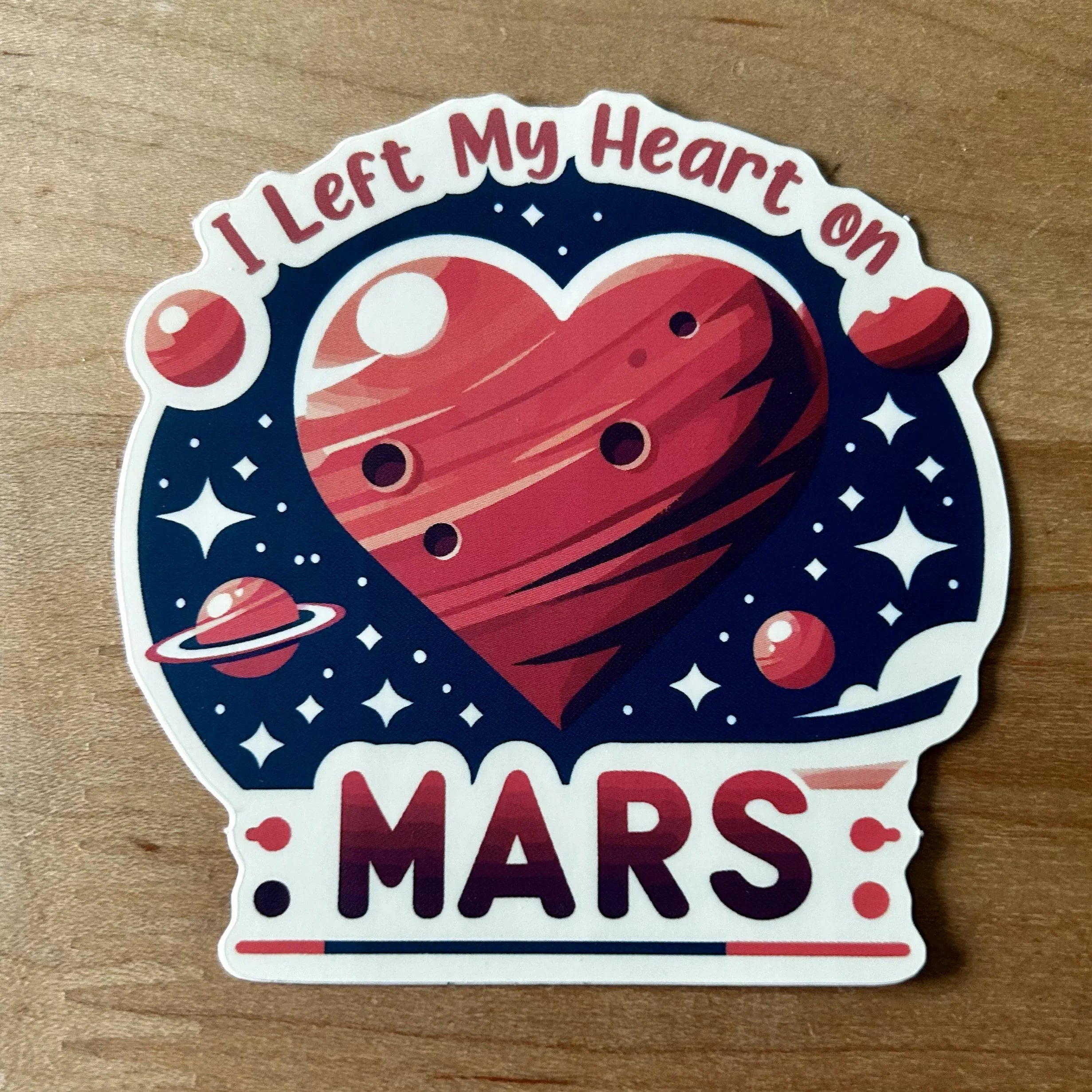 Sticker with space theme and red heart-shaped Mars planet, text I Left My Heart on Mars