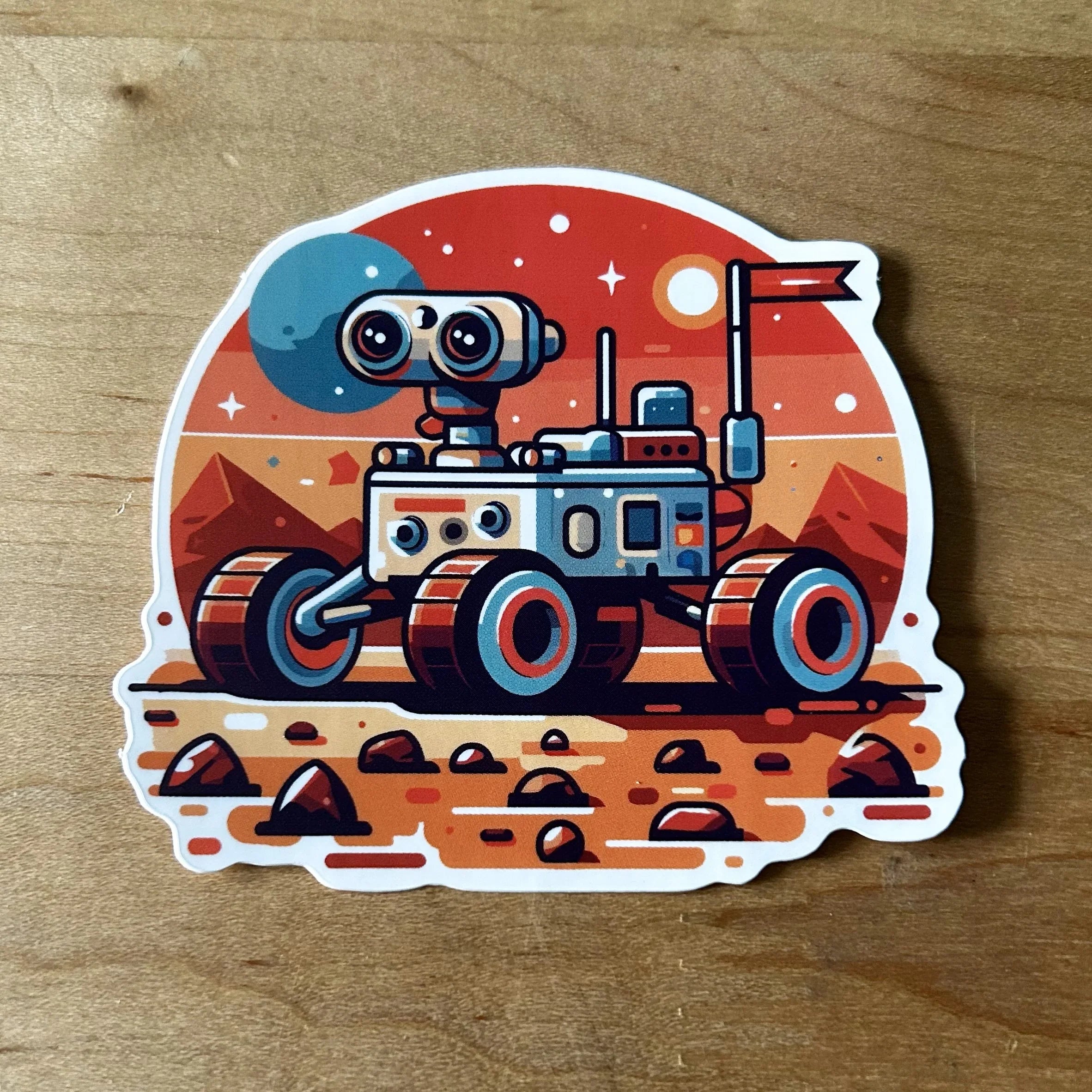 Cartoon-style sticker of a Mars rover on rocky red planet surface with mountains and two moons