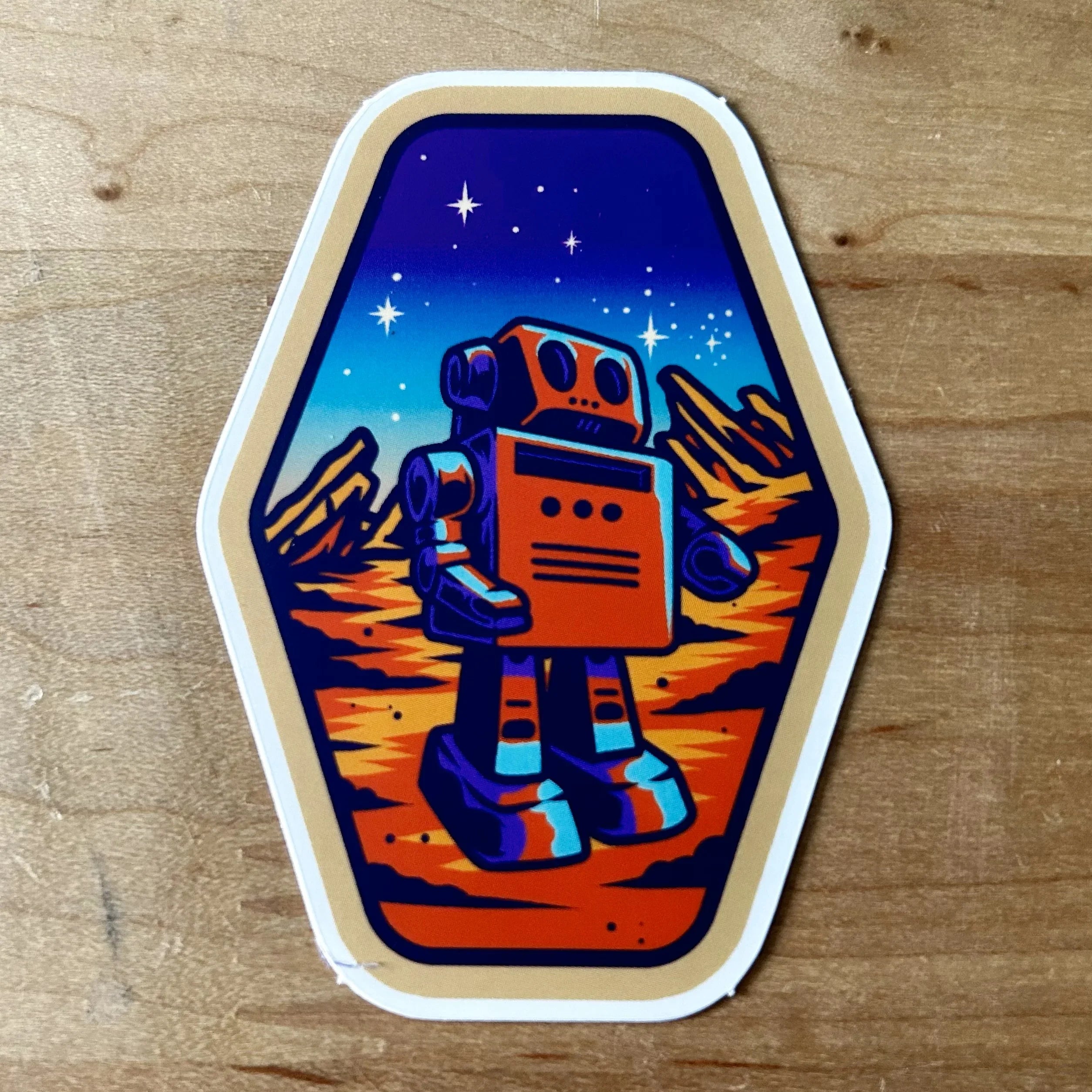 Retro-style orange and blue robot on a rocky Mars landscape under a starry night sky sticker